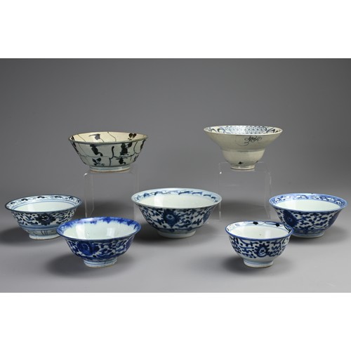 146 - A COLLECTION OF SEVEN CHINESE PORCELAIN BLUE AND WHITE BOWLS. The first probably Ming Dynasty, with ... 