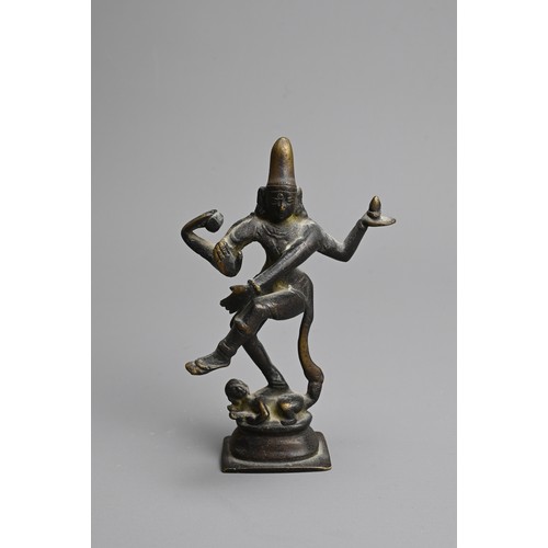 215 - AN INDIAN BRONZE FIGURE OF SHIVA. Depicted dancing, with right foot standing on the demon Apasmara, ... 