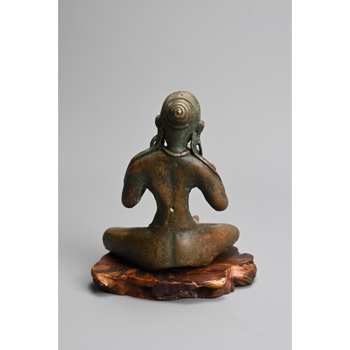 216 - A NEPALESE BRONZE FIGURE OF PARVATI, 20TH CENTURY. Together with a carved wooden base. 14cm tall.