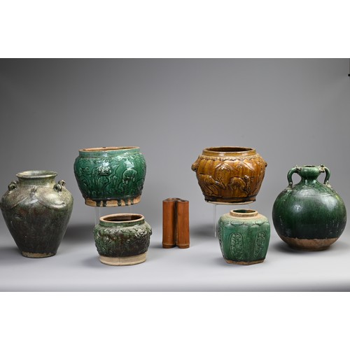 187 - A GROUP OF CHINESE GREEN AND OCHRE GLAZED STORAGE JARS AND A BAMBOO BRUSH POT. Comprising: a green g... 