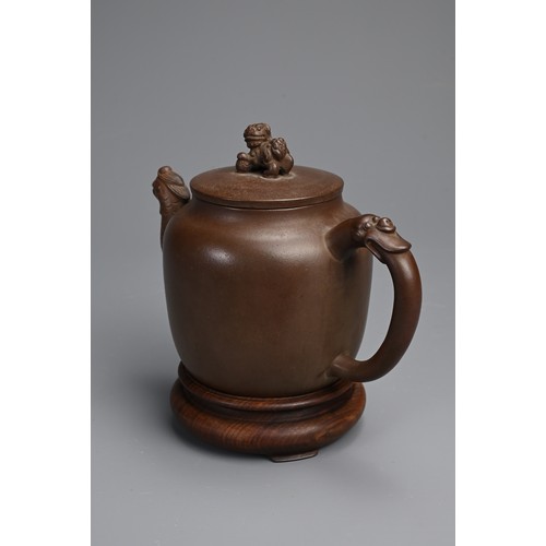 82 - A CHINESE YIXING POTTERY TEAPOT AND COVER. Featuring a phoenix head spout and zoomorphic handle, sur... 