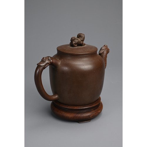 82 - A CHINESE YIXING POTTERY TEAPOT AND COVER. Featuring a phoenix head spout and zoomorphic handle, sur... 