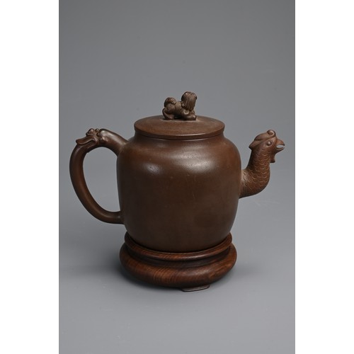 82 - A CHINESE YIXING POTTERY TEAPOT AND COVER. Featuring a phoenix head spout and zoomorphic handle, sur... 