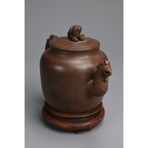 82 - A CHINESE YIXING POTTERY TEAPOT AND COVER. Featuring a phoenix head spout and zoomorphic handle, sur... 