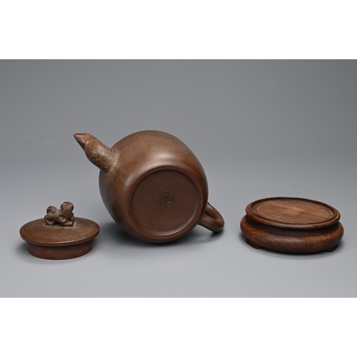 82 - A CHINESE YIXING POTTERY TEAPOT AND COVER. Featuring a phoenix head spout and zoomorphic handle, sur... 