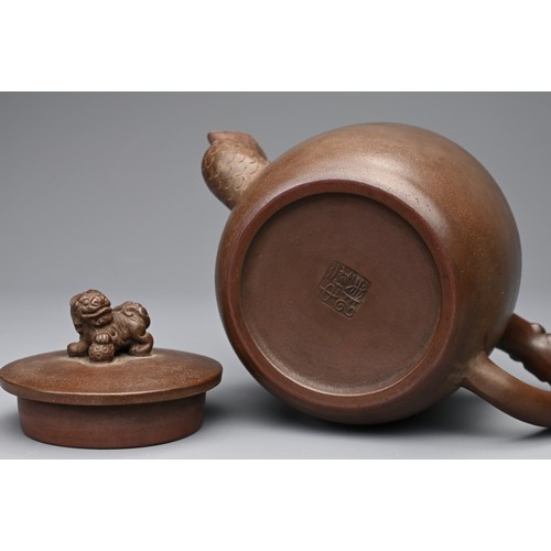 82 - A CHINESE YIXING POTTERY TEAPOT AND COVER. Featuring a phoenix head spout and zoomorphic handle, sur... 