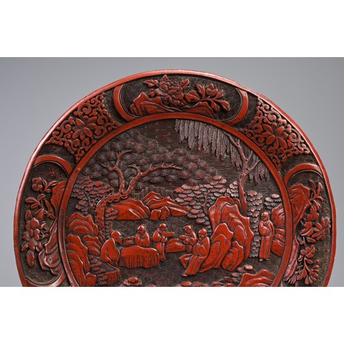 86 - A CHINESE CARVED CINNABAR LACQUER DISH, 19TH CENTURY. Carved in relief with scholars in landscape sc... 