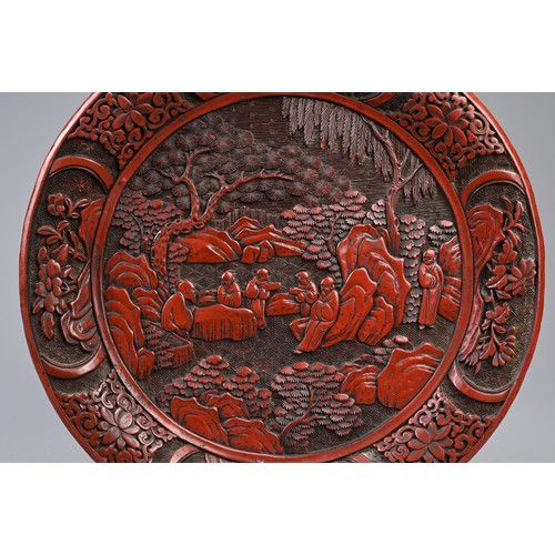 86 - A CHINESE CARVED CINNABAR LACQUER DISH, 19TH CENTURY. Carved in relief with scholars in landscape sc... 