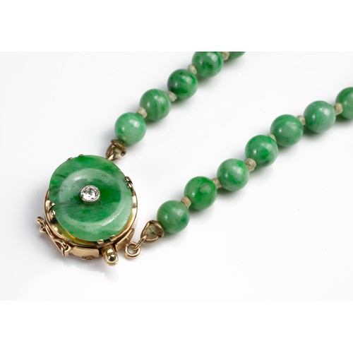 57 - A GRADUATED JADE BEAD NECKLACE WITH 14CT GOLD CLASP WITH SINGLE DIAMOND. Marked 14K. Length 76cm. Be... 