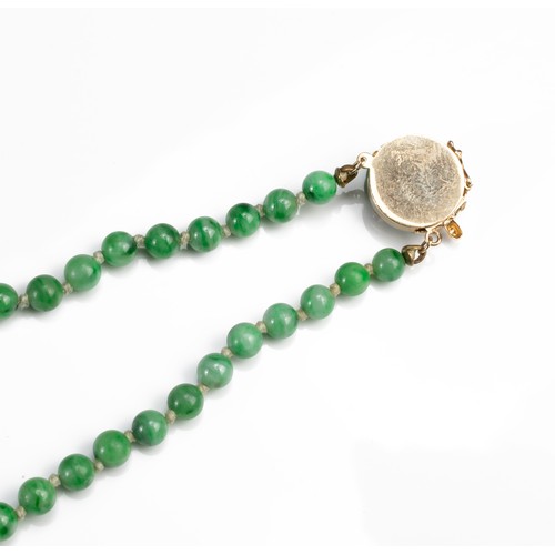 57 - A GRADUATED JADE BEAD NECKLACE WITH 14CT GOLD CLASP WITH SINGLE DIAMOND. Marked 14K. Length 76cm. Be... 