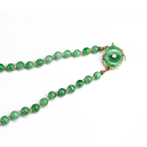 57 - A GRADUATED JADE BEAD NECKLACE WITH 14CT GOLD CLASP WITH SINGLE DIAMOND. Marked 14K. Length 76cm. Be... 