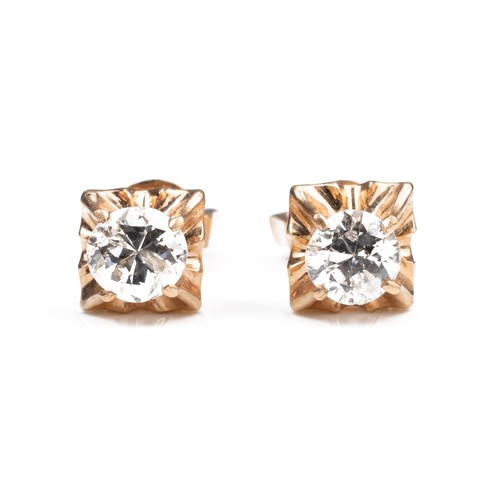 43 - A PAIR OF HIGH CARAT ROSE GOLD DIAMOND STUD EARRINGS, MID 20TH CENTURY. Single round cut diamonds in... 