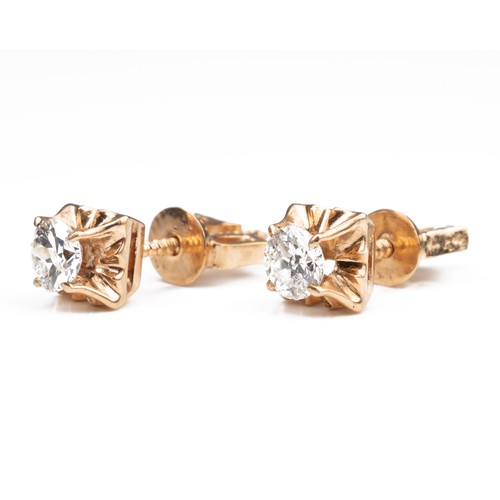 43 - A PAIR OF HIGH CARAT ROSE GOLD DIAMOND STUD EARRINGS, MID 20TH CENTURY. Single round cut diamonds in... 