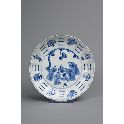 87 - A CHINESE BLUE AND WHITE PORCELAIN DISH, EARLY 18TH CENTURY. Of lobed form decorated with scholars a... 