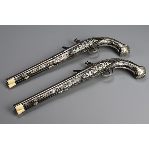 76 - A FINE PAIR OF SILVER INLAID FLINTLOCK PISTOLS BY PERRY, LONDON CIRCA 1780. Profusely inlaid with sc... 