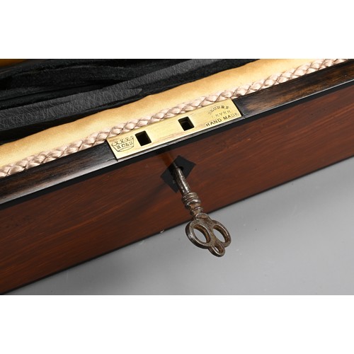 77 - AN ENGLISH REGENCY BOX WITH DISCIPLINE LEATHER WHIP SCOURGE. Rectangular mahogany box with bronze ha... 