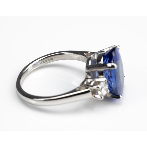 70 - A 5.71CT TANZANITE AND DIAMOND PLATINUM RING WITH INSURANCE VALUATION. A high clarity deep purplish ... 