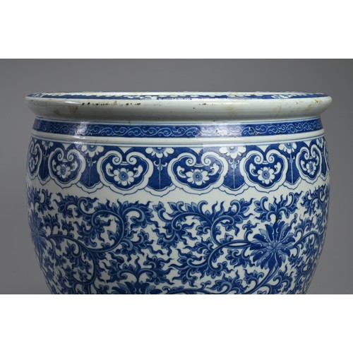 94 - A LARGE 19TH CENTURY CHINESE PORCELAIN BLUE AND JARDINIERE. Painted in the Ming style with lotus, tr... 