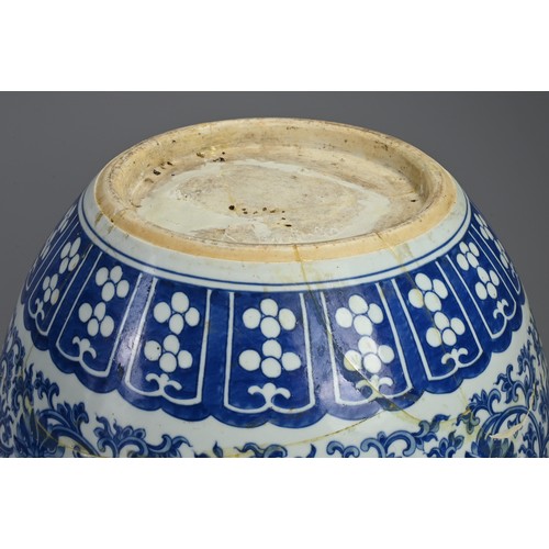 94 - A LARGE 19TH CENTURY CHINESE PORCELAIN BLUE AND JARDINIERE. Painted in the Ming style with lotus, tr... 