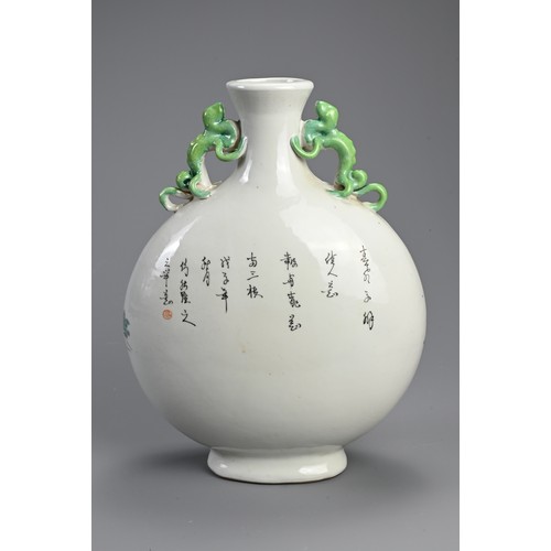 151 - A CHINESE FAMILLE ROSE PORCELAIN MOONFLASK. With green glazed chilong form handles, decorated with l... 