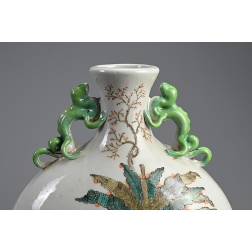 151 - A CHINESE FAMILLE ROSE PORCELAIN MOONFLASK. With green glazed chilong form handles, decorated with l... 