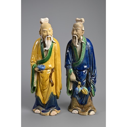 166 - A LARGE PAIR OF CHINESE SHIWAN POTTERY FIGURES, EARLY 20TH CENTURY. Sancai glazed standing figures d... 