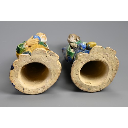 166 - A LARGE PAIR OF CHINESE SHIWAN POTTERY FIGURES, EARLY 20TH CENTURY. Sancai glazed standing figures d... 