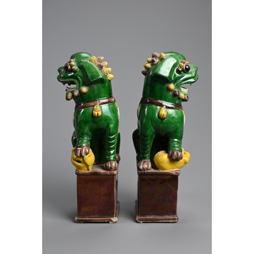 169 - A PAIR OF CHINESE SANCAI GLAZED PORCELAIN JOSS STICK HOLDERS, 19/20TH CENTURY. In the form of a foo ... 