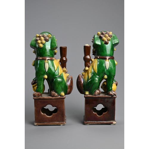 169 - A PAIR OF CHINESE SANCAI GLAZED PORCELAIN JOSS STICK HOLDERS, 19/20TH CENTURY. In the form of a foo ... 