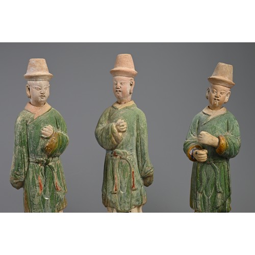 171 - THREE LARGE CHINESE SANCAI GLAZED POTTERY MODELS OF ATTENDANTS, MING DYNASTY (1368-1644). Standing d... 