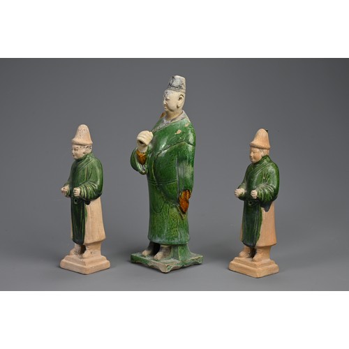 172 - THREE SANCAI AND GREEN GLAZED POTTERY MODELS OF ATTENDANTS, MING DYNASTY (1368-1644). Dressed in rob... 