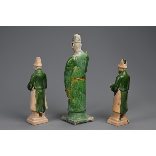 172 - THREE SANCAI AND GREEN GLAZED POTTERY MODELS OF ATTENDANTS, MING DYNASTY (1368-1644). Dressed in rob... 