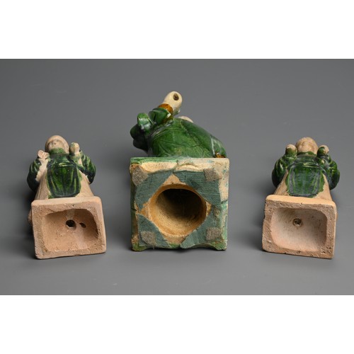 172 - THREE SANCAI AND GREEN GLAZED POTTERY MODELS OF ATTENDANTS, MING DYNASTY (1368-1644). Dressed in rob... 