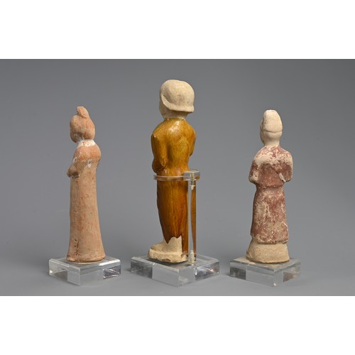 173 - A CHINESE SANCAI GLAZED POTTERY FIGURE WITH TWO OTHER PAINTED FIGURES OF ATTENDANTS, TANG DYNASTY (6... 