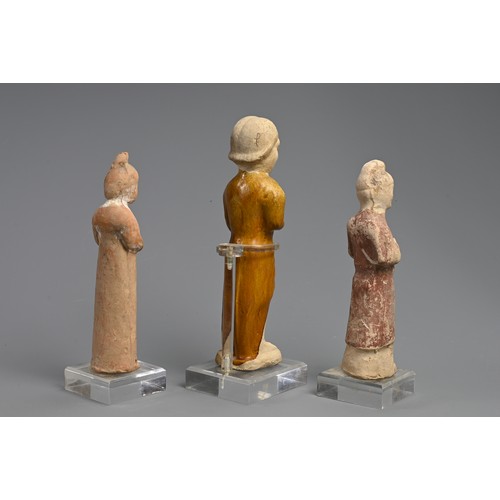 173 - A CHINESE SANCAI GLAZED POTTERY FIGURE WITH TWO OTHER PAINTED FIGURES OF ATTENDANTS, TANG DYNASTY (6... 