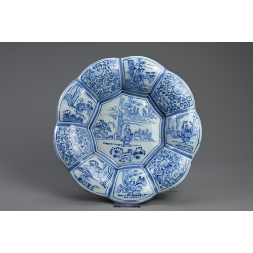 191 - A DELFT TIN GLAZED EARTHENWARE DISH, 17/18TH CENTURY. Of flared lobed form decorated in the Chinese ... 