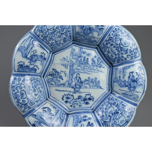 191 - A DELFT TIN GLAZED EARTHENWARE DISH, 17/18TH CENTURY. Of flared lobed form decorated in the Chinese ... 