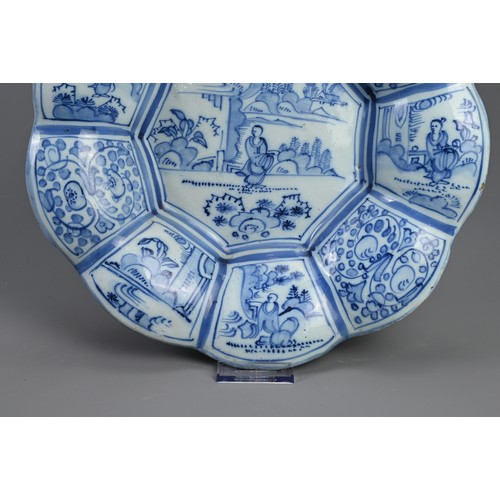 191 - A DELFT TIN GLAZED EARTHENWARE DISH, 17/18TH CENTURY. Of flared lobed form decorated in the Chinese ... 