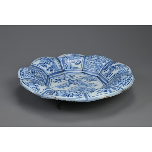 191 - A DELFT TIN GLAZED EARTHENWARE DISH, 17/18TH CENTURY. Of flared lobed form decorated in the Chinese ... 