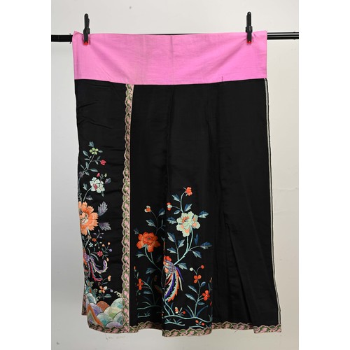 227 - TWO 20TH CENTURY CHINESE EMBROIDERED SILK SKIRTS AND A JACKET. The first skirt in black silk embroid... 