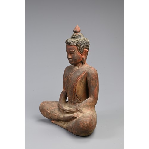 205 - A 20TH CENTURY THAI RED PAINTED WOODEN STATUE OF A BUDDHA. In bhumisparsha mudra, with hands cupped,... 