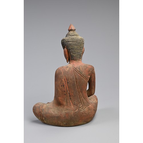 205 - A 20TH CENTURY THAI RED PAINTED WOODEN STATUE OF A BUDDHA. In bhumisparsha mudra, with hands cupped,... 