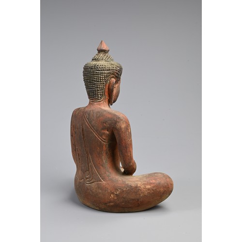 205 - A 20TH CENTURY THAI RED PAINTED WOODEN STATUE OF A BUDDHA. In bhumisparsha mudra, with hands cupped,... 