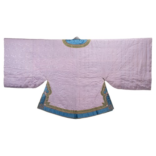 235 - EARLY 20TH CENTURY CHINESE LILAC SILK WINTER ROBE. With flared wide sleeves, edge in blue silk with ... 