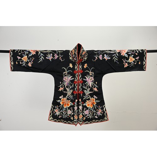 227 - TWO 20TH CENTURY CHINESE EMBROIDERED SILK SKIRTS AND A JACKET. The first skirt in black silk embroid... 