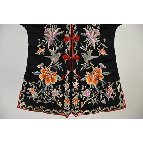 227 - TWO 20TH CENTURY CHINESE EMBROIDERED SILK SKIRTS AND A JACKET. The first skirt in black silk embroid... 