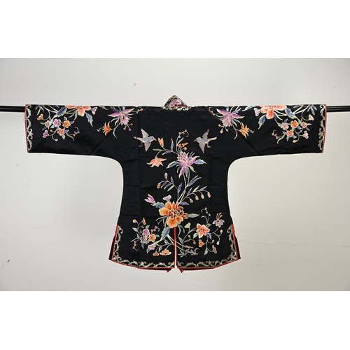 227 - TWO 20TH CENTURY CHINESE EMBROIDERED SILK SKIRTS AND A JACKET. The first skirt in black silk embroid... 