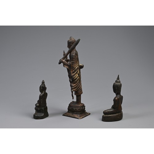 209 - THREE SOUTH EAST ASIAN BRONZE MODELS OF BUDDHAS. Comprising: a buddha Shakyamuni, Laos, seated in dh... 