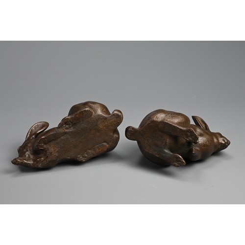 308 - A PAIR OF JAPANESE BRONZE OKIMONO OF HARES, USAGI, EARLY 20TH CENTURY. Naturalistically modelled in ... 