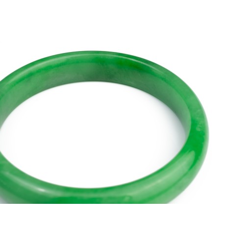 58 - A JADEITE CIRCULAR BANGLE. Of D shape. Total diameter 7cm, Inner diameter 5.7mm. Weight 41.7 grams